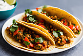 Appetizing Mexican tacos with spicy chili peppers and cilantro on plate. Generative AI