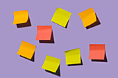 Colorful black sticky notes placed on bright violet background representing concept of idea in creative office