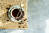 Cup of bulletproof keto coffee served on concrete table in the sunny morning