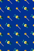 Top view of pattern of whole sweet crystal candies and lollipops arranged on blue background