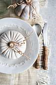 Top view of autumnal table setting with white pumpkin on plate placed on table near cutlery and glass