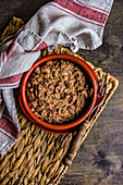 Famous Georgian Lobio with walnuts dish served in ceramic bowl on wooden table
