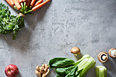 Food concept, flat lay with fresh fruits and vegetables on gray background with copy space