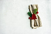 Table cloth napkin with cutlery setting for Christmas dinner on concrete table on white background