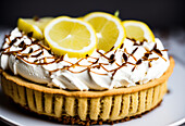 Appetizing sweet lemon cake with meringue served on white ceramic plate