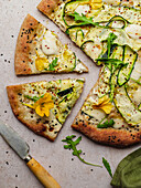 Top view of tasty pizza with arugula leaves on melted mozzarella cheese with black sesame seeds