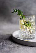 Glass of morning pure water with lemon and fresh mint on the table