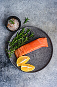 Healthy plate with salmon fish , lemons and rosemary herbs