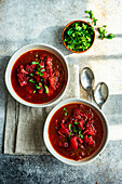 Tasty Ukrainian beetroot soup known as a Borscht served in the bowl on stone table