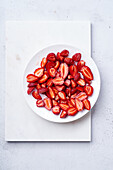 Sugar-coated sliced strawberries on a plate. Cooking dessert or jam