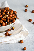 Bowl with organic hazelnuts on the napkin