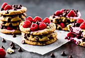 Appetizing sweet cookie sandwiches with chocolate drops served with ice cream and raspberries