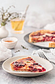 From above tasty fresh slice of quiche with red beet on white plate on served light table indoors