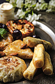 High angle of assorted tasty Arabic food with salsa and fresh mint leaves near almonds during Ramadan holidays