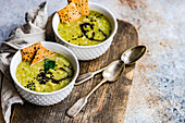 From above healthy zucchini soup in the bowl with crackers