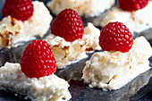 Appetizing delicious creamy dessert with fresh ripe raspberries placed on plate in cafe