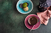 From above geyser coffee maker near glass of coffee and traditional turkish pakhlava on concrete table