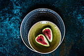 Ripe fig slices on the plates on concrete background