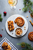 Top view of delicious homemade baked assorted pastries placed on plate with Christmas decoration around
