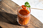 Bloody Mary or Caesar cocktail drink served in the glass on concrete background