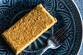 Top view of gourmet honey cake served on ceramic plate