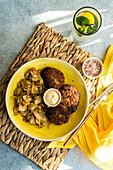 Ketogenic bowl with stewed cabbage and meat cutlets on rustic background