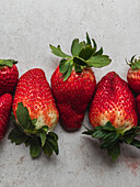 Top view of harvest of pile of fresh strawberries served on table in kitchen