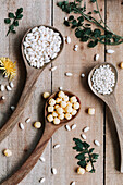 Wooden spoons with cereal over rustic wooden table