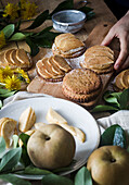 Anonymous person taking delicious apple tartlet from table in kitchen at home