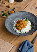 From above chicken garam tikka masala served on plate on wooden table background