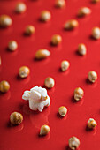 Closeup of some popcorn on a red background