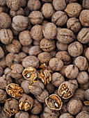 Full frame background of pile with unpeeled walnuts placed on heap in local market