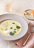 Spargel-Mascarpone-Cremesuppe von oben neben Serviette und Getränk auf dem Tisch