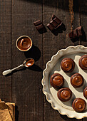 From above salted caramel chocolate cookies on ceramic plate on wooden table background