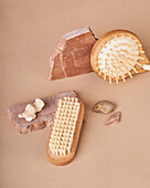 From above of eco friendly brushes and natural soap bars with pumice stone and mineral on beige background