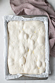 Top view of homemade dough placed on baking paper for cooking traditional bread