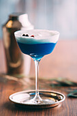 Blue cocktail on a wooden table