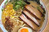 Stock photo of delicious noodle soup with boiled egg and meat in japanese restaurant.