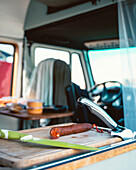 Geräucherte Chorizo-Wurst neben einem Messer auf einem hölzernen Schneidebrett in einem Wohnwagen im Urlaub in Kantabrien