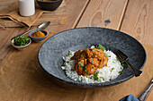 From above chicken garam tikka masala served on plate on wooden table background