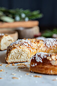 Delicious three kings cake pieces with coconut flakes and almond petals during Epiphany holiday on dark background