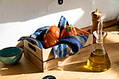 High angle of fresh ripe red tomatoes placed on natural wooden tray with napkin in home kitchen