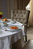 Various colorful dishes and juices served on round table during breakfast in elegant hotel restaurant in sunny morning