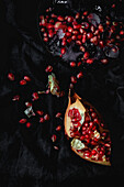 Fresh and red pomegranate on dark background. Fall season fruit. Top flay; top view