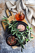 Spices in the bowls and olive oil on concrete table