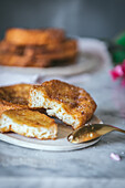 Homemade traditional easter Spanish French toast dessert served on plate near a rose flower on marple background