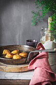 Pan with oil frying nun's puffs bites placed on table in kitchen at home