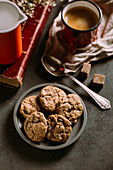 Homemade chocolate chips cookies on a old vintage book served with coffee on a mug