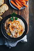 Delicious hummus with paprika, olive oil and some bread to dip