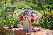 Bouquet of roses (Rosa), wild carrot, perennial vetch (Lathyrus latifolius), autumn anemone (Anemone Japonica), bearded flower (Caryopteris), oregano in a jug